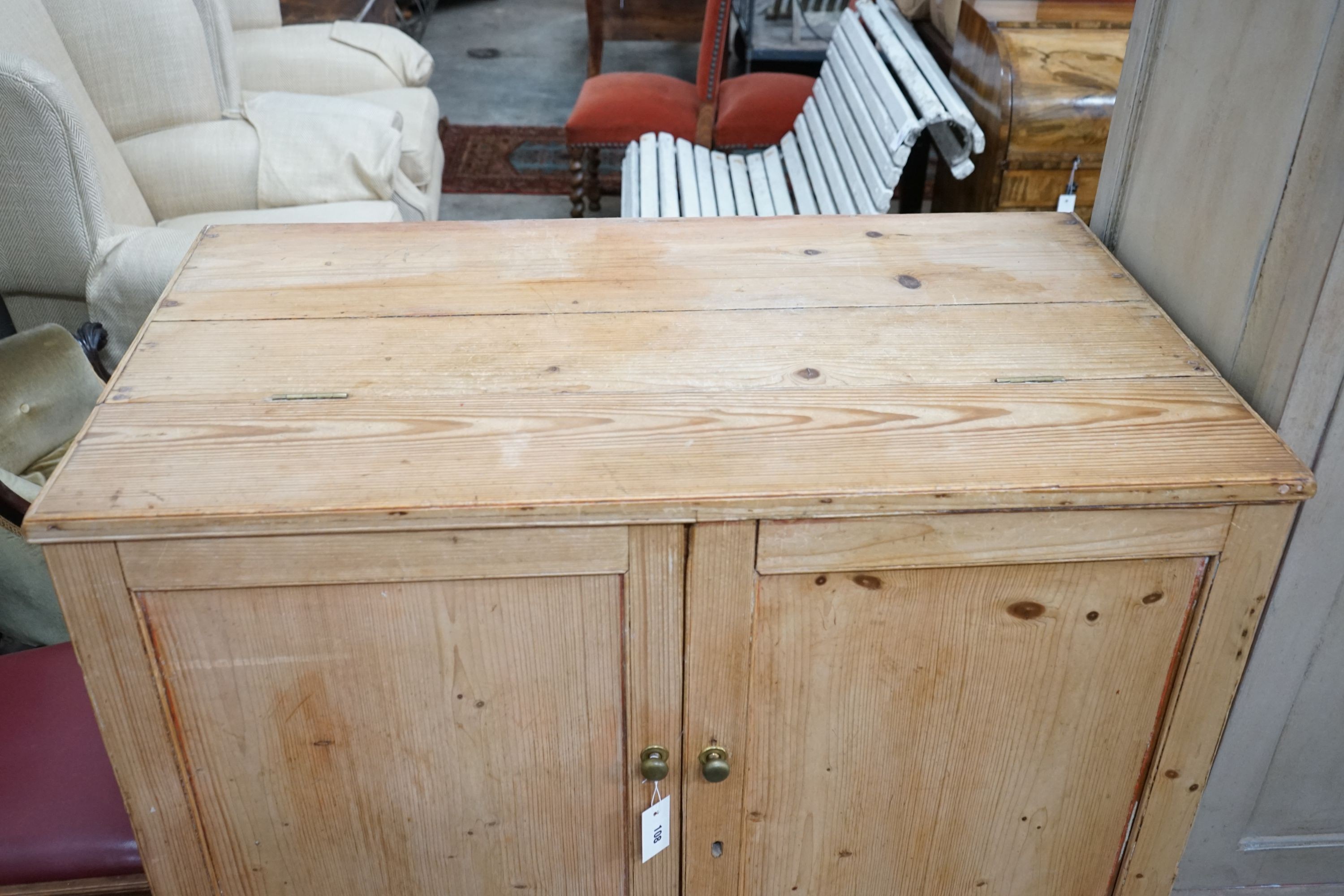 A 19th century pine part hinged top press cupboard, length 107cm, depth 61cm